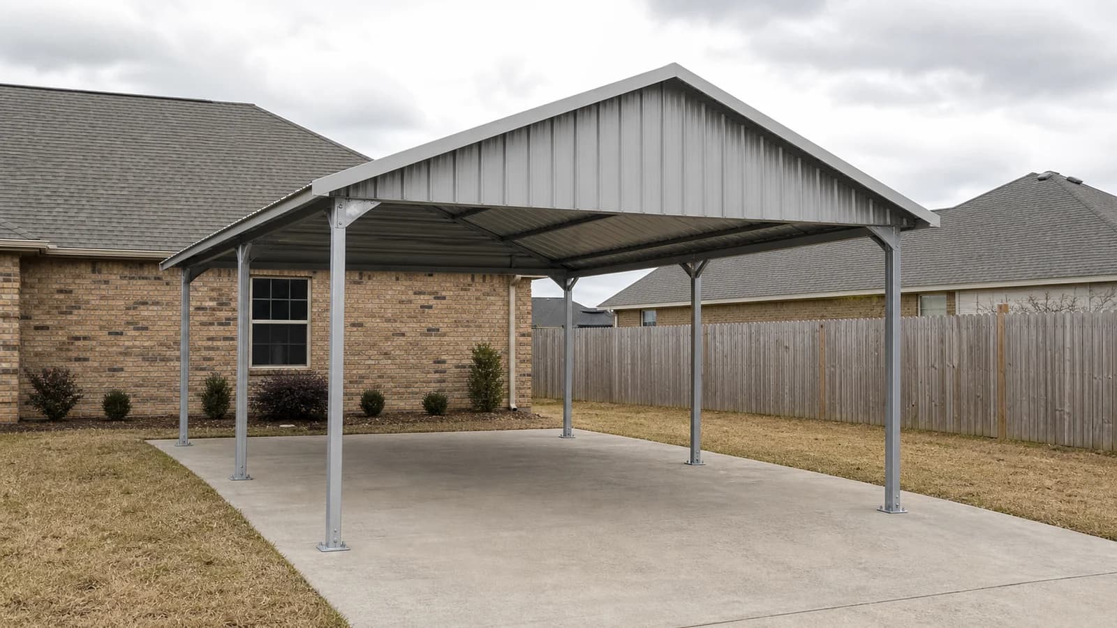 A 22 by 31 vertical roof carport standing on a poured concrete pad, the line a lot carries beside its sheds and prices on completely different logic.